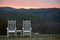 Chairs and Table Overlooking Hills at Sunset