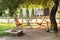 Chairs and table table in summer garden with outdoor stone fireplace. Wooden outdoor furniture set for Picnic or leisure time in n