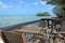 Chairs and tables against Taakoka islet Muri Lagoon Rarotonga C