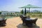 Chairs,tables and sunshades on planked roof terrace of uptown bu