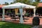 Chairs and Tables under Gazebo with White Tent