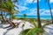 Chairs under the palm trees on paradise beach at tropical Resort. Riviera Maya - Caribbean coast at Tulum in Quintana Roo, Mexico