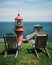 Chairs and view of Pointe-Ã -la-RenommÃ©e Lighthouse, GaspÃ©, QuÃ©bec, Canada