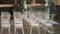 Chairs at a wedding ceremony. Decorated with flower arrangements