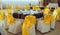 Chairs with yellow cloth and table for guests served for wedding.