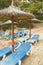 Chaise Lounges and straw umbrellas on the beautiful sandy beach of Palma de Mallorca