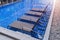 Chaise lounges in swimming pool