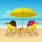 Chaise lounges with umbrella on idyllic tropical sandy beach. Seaside landscape background. Summer holiday vacation