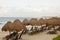 Chaise Lounges Under Straw Thatched Umbrellas