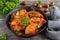 Chakhokhbili, chicken stew, cooked with tomatoes, bell peppers, spices and herbs. Dark wooden background