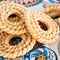 Chakli famous South Indian Traditional Snack. Spiral shaped crisp fried snack. Selective focus. Indian pattern background. Square