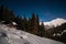 The chalet in the mountains in winter time at night