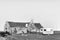 Chalet, toilet facilities and a caravan at Matjiesfontein farm. Monochrome