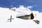 Chalet and wooden cross in deep snow