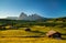 Chalets at Seiser Alm with Langkofel mountain in background at sunrise, Dolomites, South Tyrol, Italy