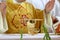 Chalice on the altar and priest celebrating mass in the background