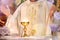 Chalice at the altar with rays of light and Priest celebrate mass