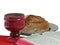 Chalice, bread and bible on white background