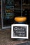 Chalk and blackboard sign advertising a cheese shop at shop entrance