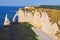 Chalk cliffs at Cote d`Albatre rocks and natural arch landmark and blue ocean in Etretat. Normandy France.
