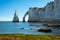 Chalk cliffs of Etretat with the natural arch Porte d`Aval and the stone needle called L`Aiguille