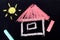 chalk drawing on a chalkboard: small house with pink roof