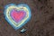 Chalk drawing: colorful hearts on asphalt