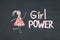 Chalk drawing icon of woman in dress from pink live flowers. GIRL POWER inscription on chalkboard or blackboard. Lettering text s