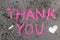 Chalk drawing: Pink words THANK YOU and small heart