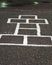 Chalk hopscotch game on asphalt