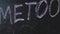 Chalk inscription on black chalkboard with hashtag Me Too. Social media movement on widespread prevalence of sexual assault and ha