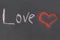 Chalk inscription on a blackboard, symbol love heart red