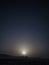 Chalk and limestone remnants in the Kazakh steppe at night against the background of the starry sky and the moon