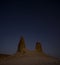 Chalk and limestone remnants in the Kazakh steppe at night against the background of the starry sky and the moon