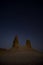 Chalk and limestone remnants in the Kazakh steppe at night against the background of the starry sky and the moon