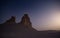 Chalk and limestone remnants in the Kazakh steppe at night against the background of the starry sky and the moon