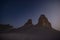 Chalk and limestone remnants in the Kazakh steppe at night against the background of the starry sky and the moon