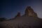 Chalk and limestone remnants in the Kazakh steppe at night against the background of the starry sky and the moon