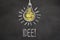 Chalk text `Idee` and lightbulb on chalkboard. Translation: `Idea`