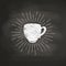 Chalk textured coffee cup silhouette with vintage sun rays on black board.