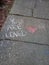 Chalk Words on Sidewalk You Are Loved with Pink Heart