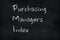 Chalk writing on a slate board â€“ Purchasing Managers Index