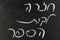 Chalkboard with Back to School in Hebrew written on the black board.