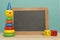 Chalkboard with on a blue background with wooden child toys in the front