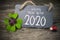 Chalkboard with four leaf clover and chimney sweeper and sparklers with happy new year 2020