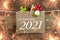 Chalkboard with four leaf clover and chimney sweeper and sparklers with happy new year 2021 on wooden background
