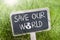 Chalkboard in the grass with save our world