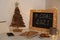 Chalkboard with hashtag Goal 2021, fairy lights near notebooks, smartphone and cookies. New year targets