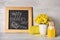 Chalkboard with inscription HAPPY TEACHER`S DAY, stationery and vase of flowers on wooden table