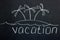 Chalkboard lettering `Vacation` with painted island and palm trees